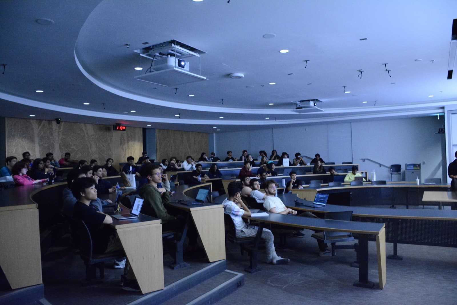 Hackers working in a lecture hall at HawkHacks 2024